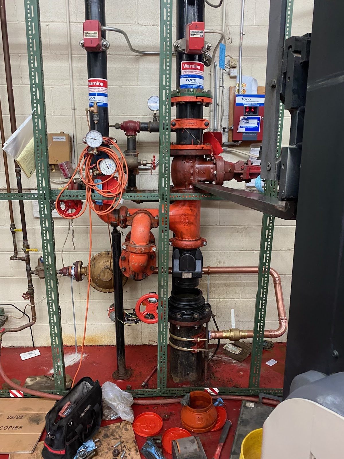 Commercial backflow preventer and red fire-service piping installed in New Jersey