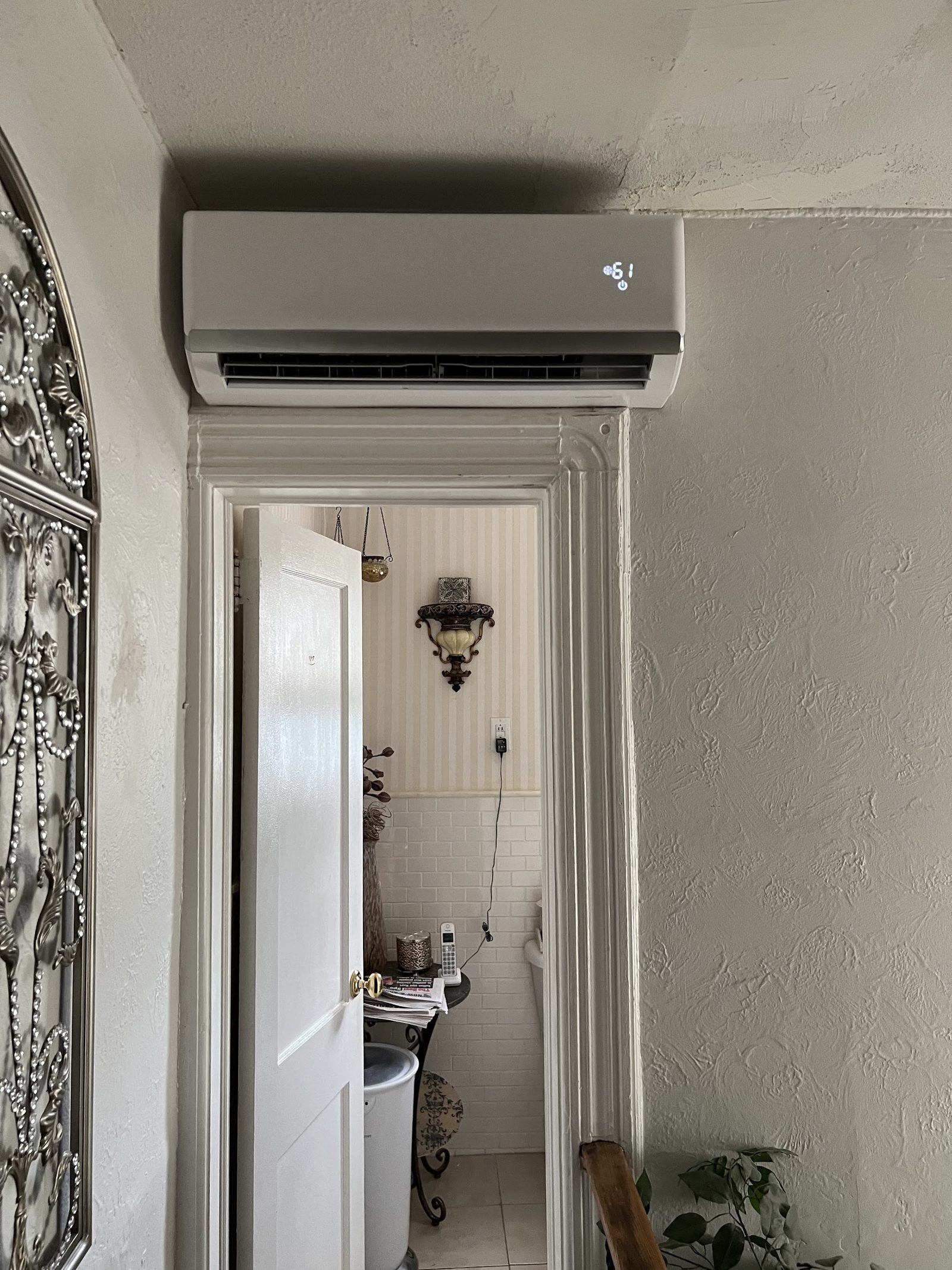 Ductless mini split indoor wall unit installed above a doorway in a New Jersey home