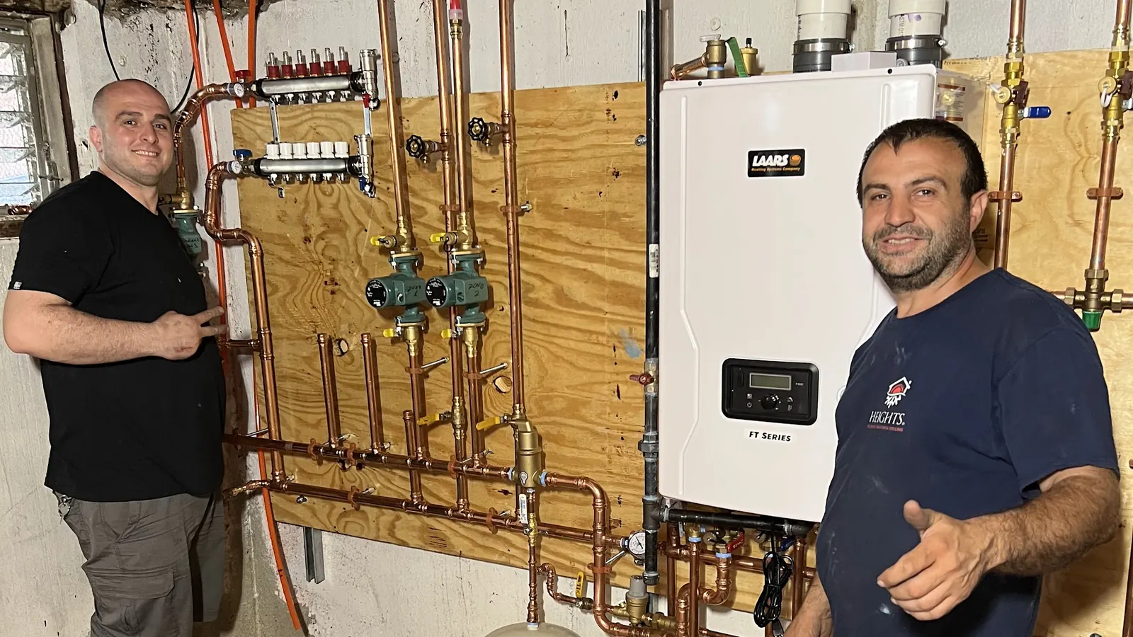Heights plumber with a happy homeowner after a tankless water heater installation in Bergen County, NJ