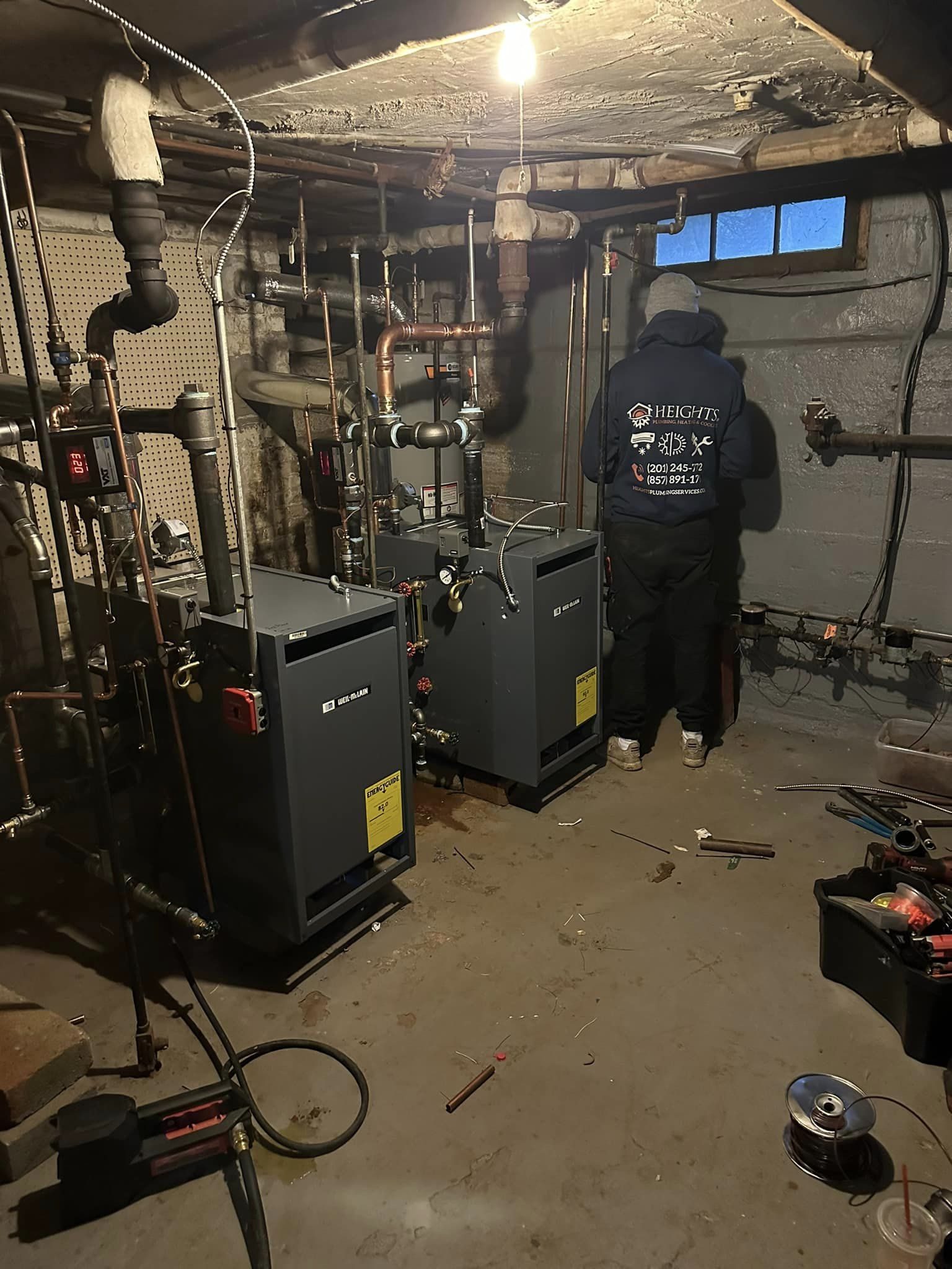 Heights technician finishing a gas boiler installation in a New Jersey basement